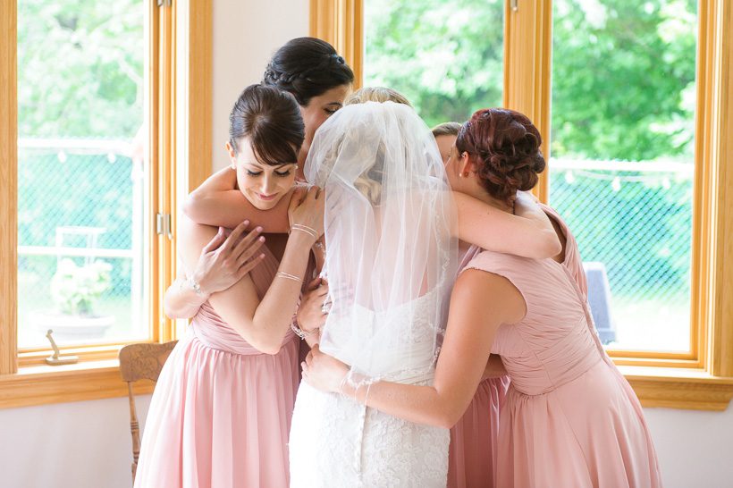 Bride and bridesmaids hugging