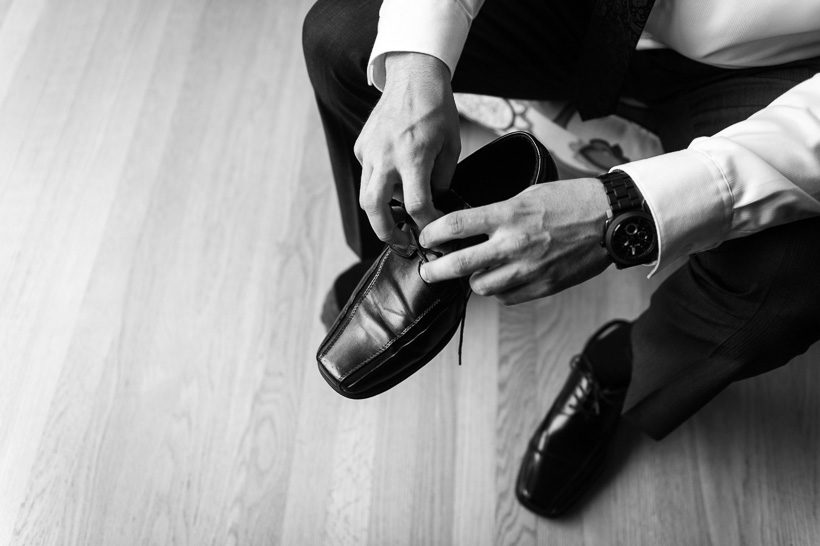 Groom putting on shoes