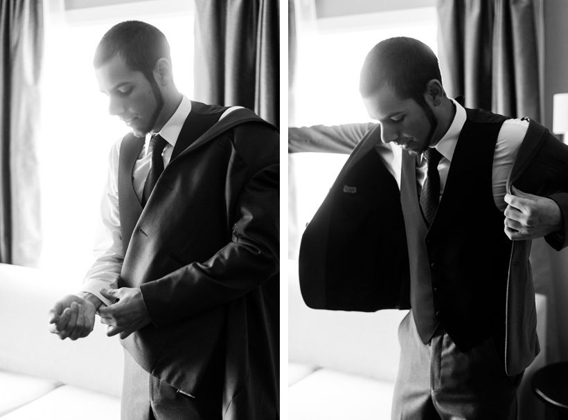 Groom putting on suit