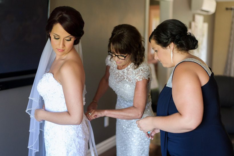bride putting on dress