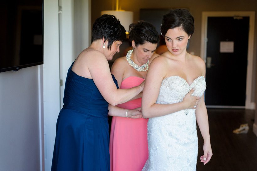 Bride putting on her dress
