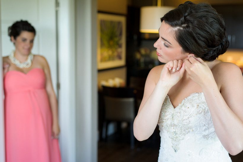 bride putting on earrings