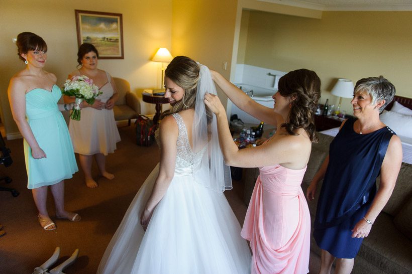 bride putting on veil