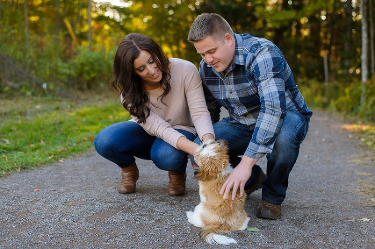 Couple playing with small dog