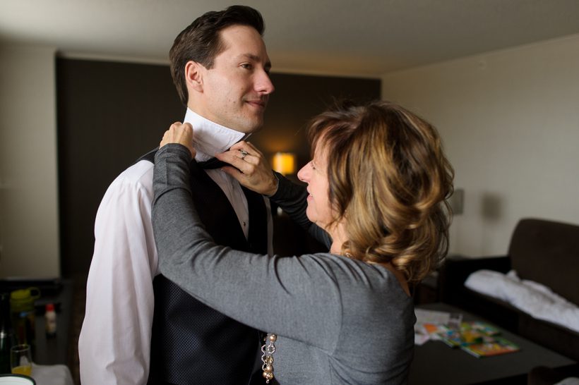 mother helping groom