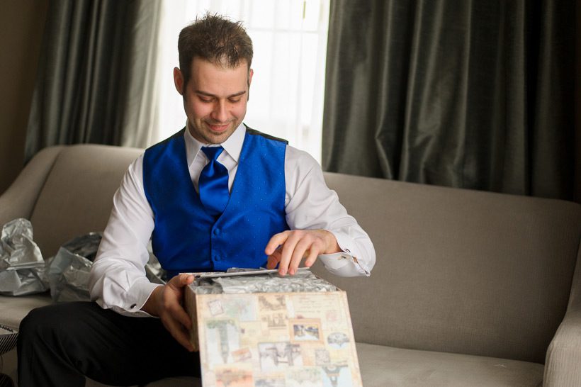 groom opening gift from bride