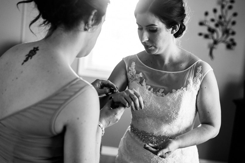 Sister helping bride with bracelet
