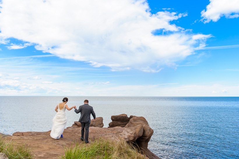 Bride and groom walking to water