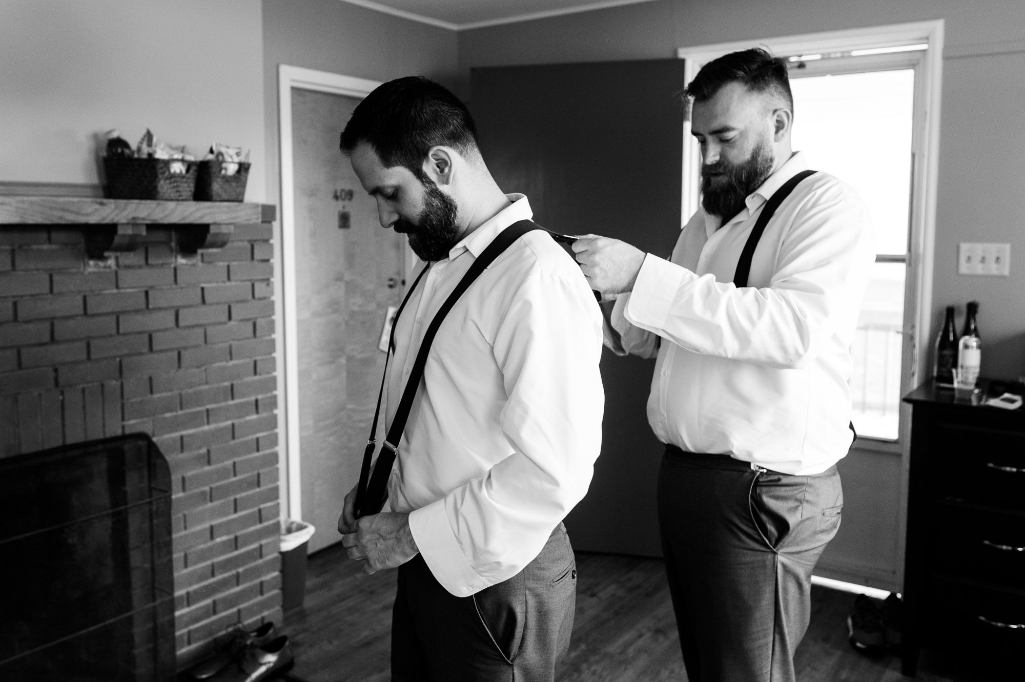 Groom getting dressed on wedding morning