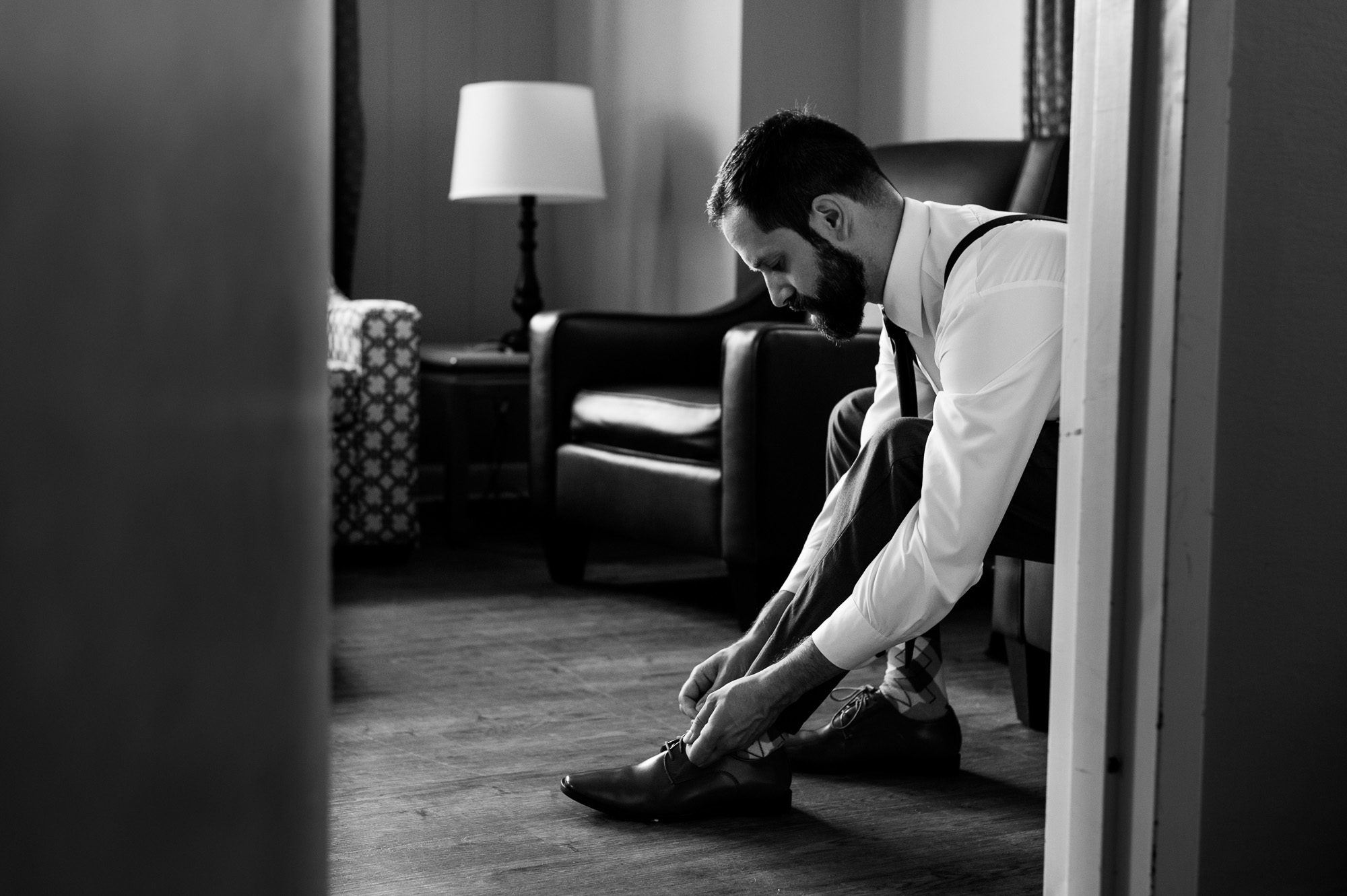 Groom putting on shoes