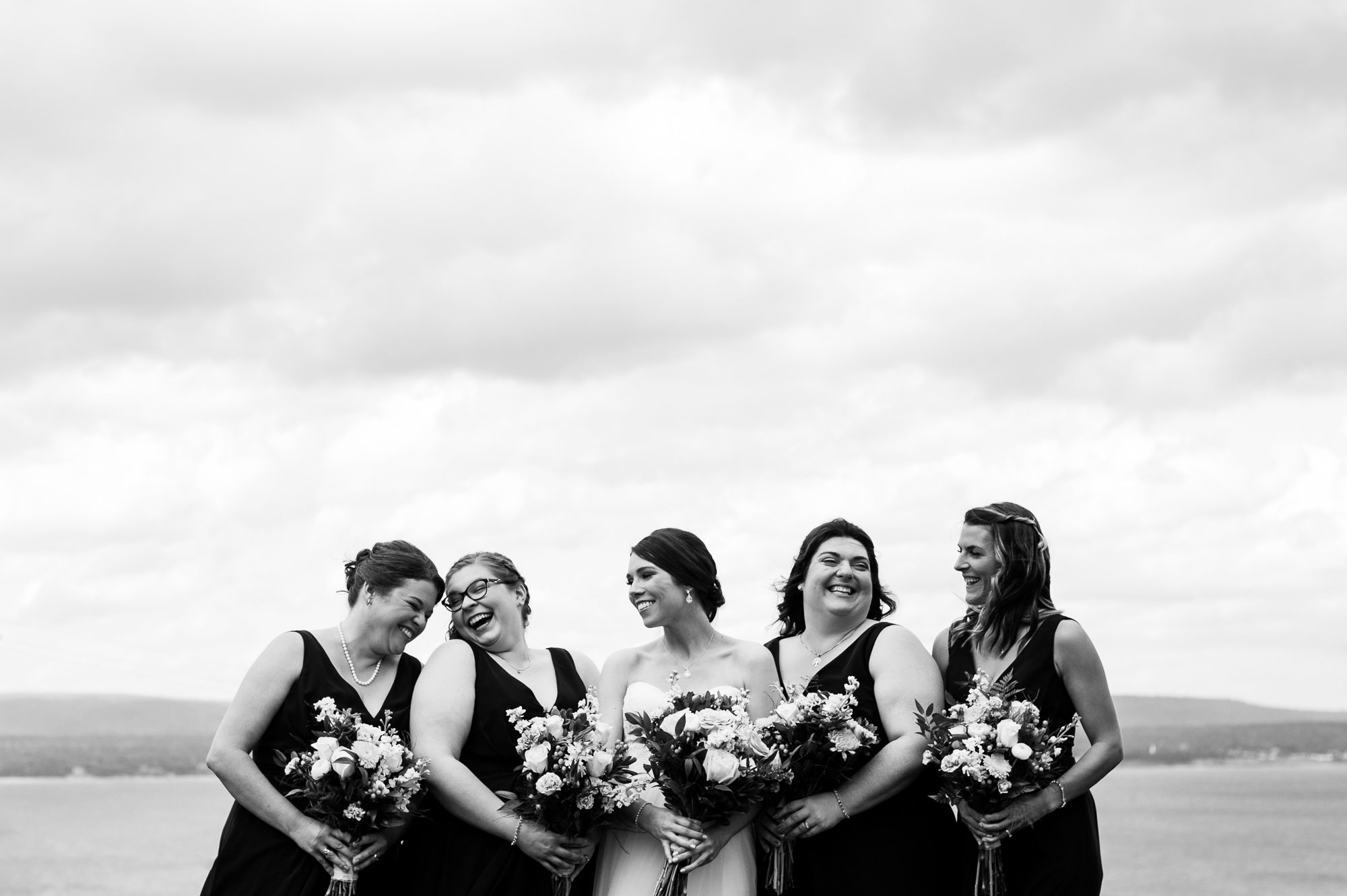 Bride and bridesmaids laughing
