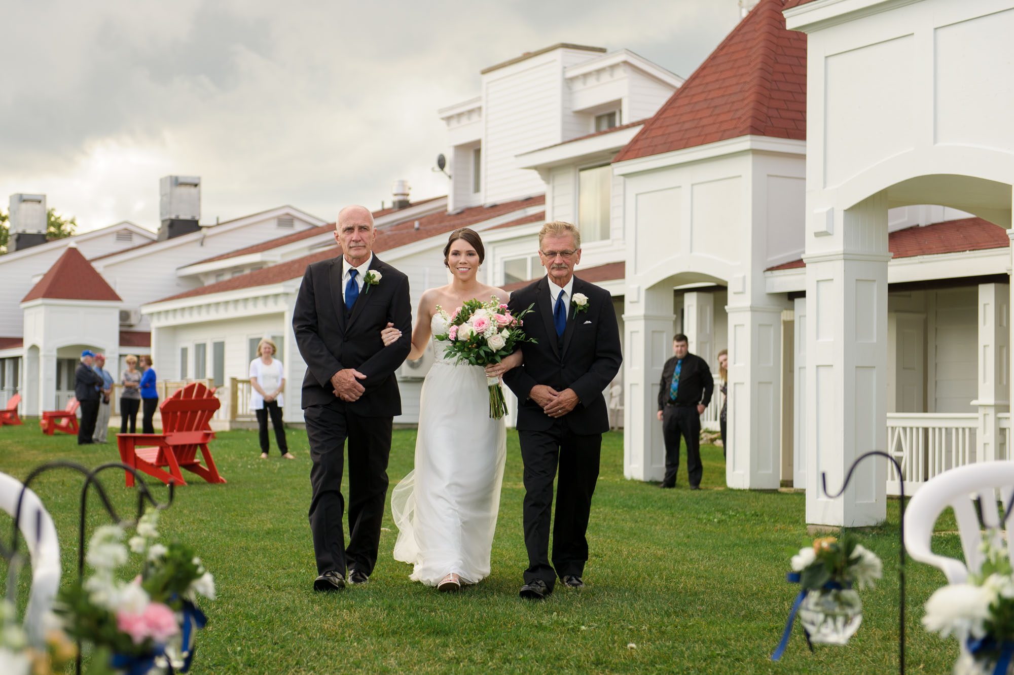 Bride walking down the aisle with fathers