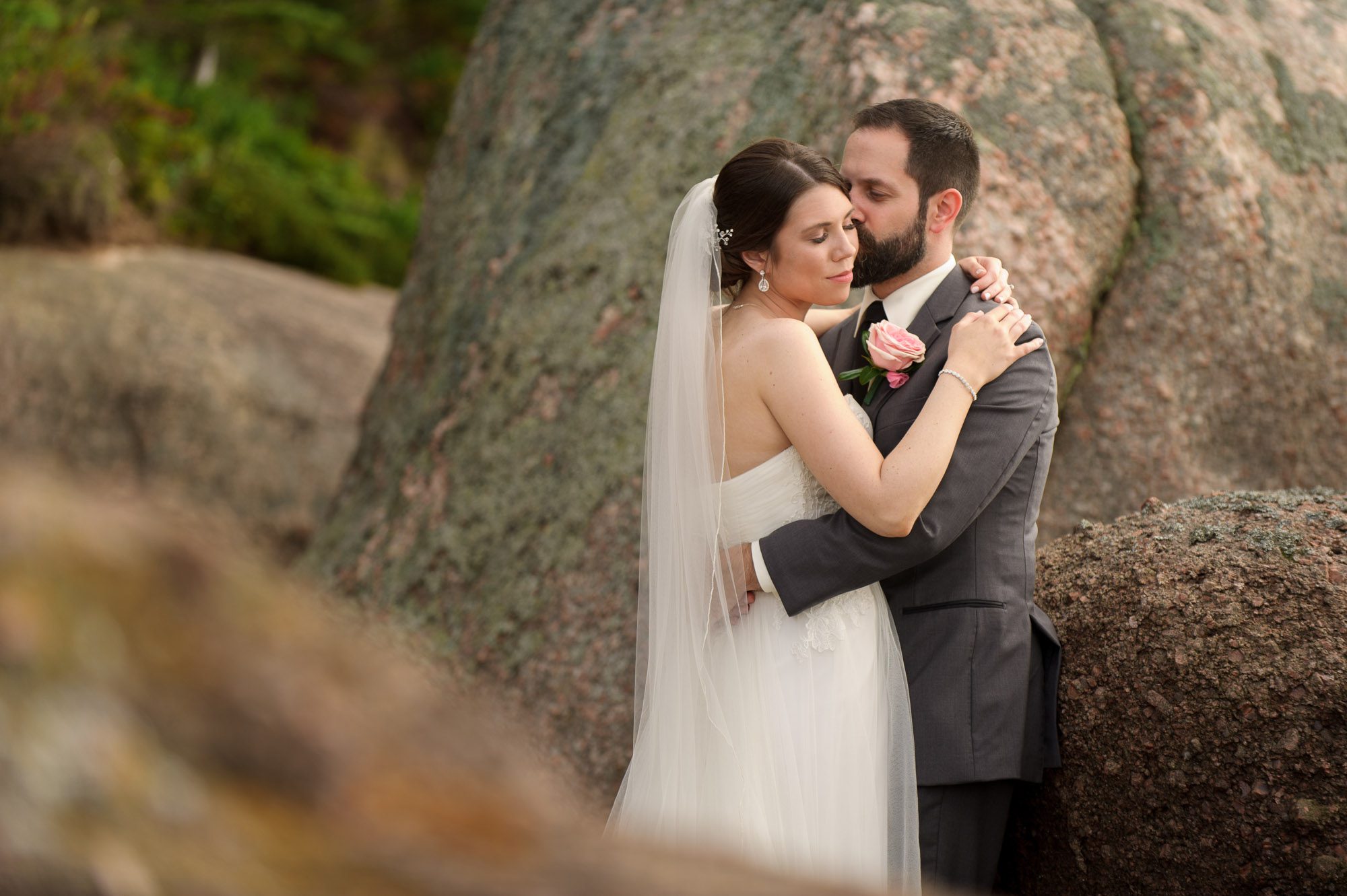 Groom kissing bride on the beach