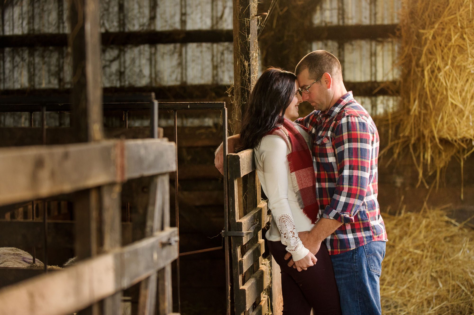 Couple holding hands in a barn