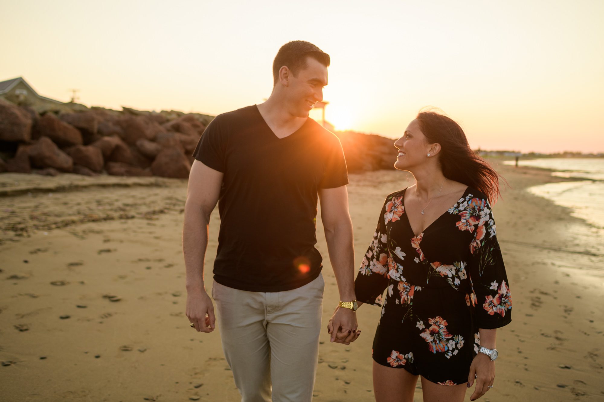 Couple walking on the beach at sunset
