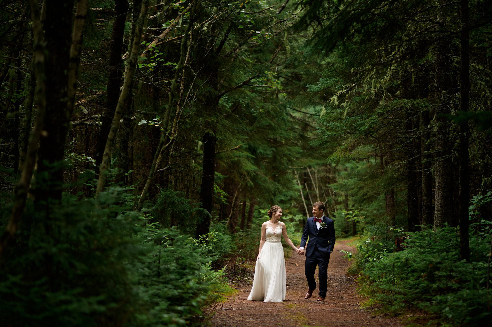 Couple walking in the woods - Wedding Photographer