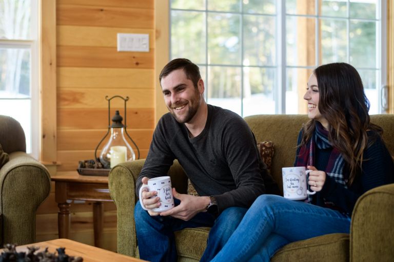 Couple having a coffee on the sofa