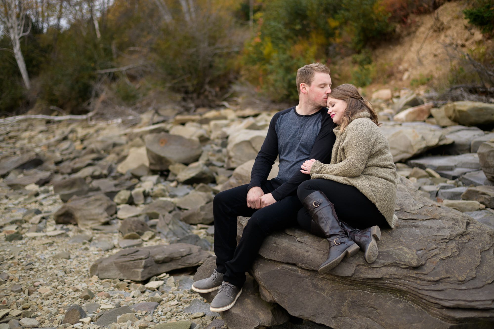 Couple sitting on rocks at the beacj