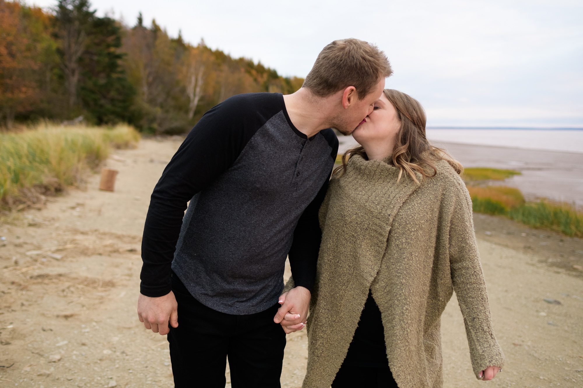 Couple kissing on the beach at sunset